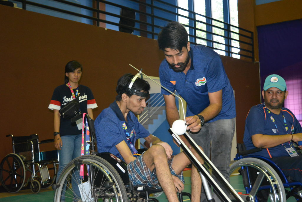 persons with cerebral palsy playe BOCCIA game with guideline from the coach