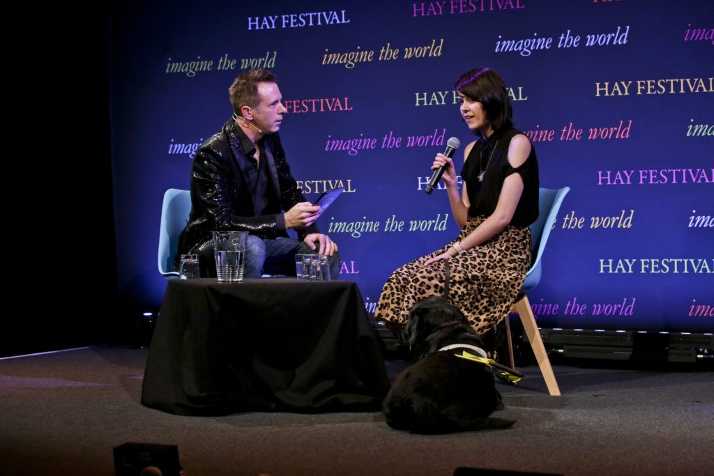 Maisy McAdam with GiveVision glasses on Hay Festival stage 